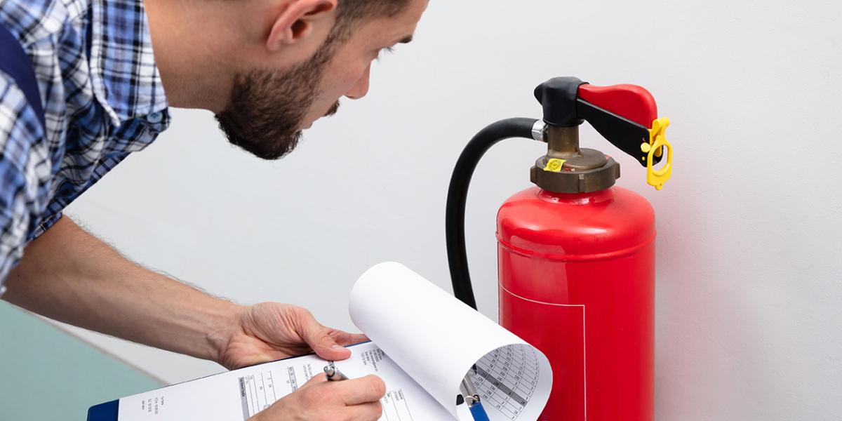 man reviewing fire extinguisher