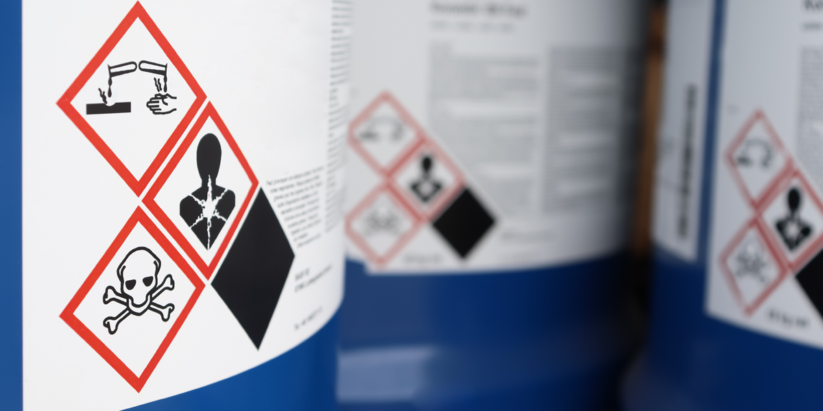 close-up of chemical waste stickers on containers