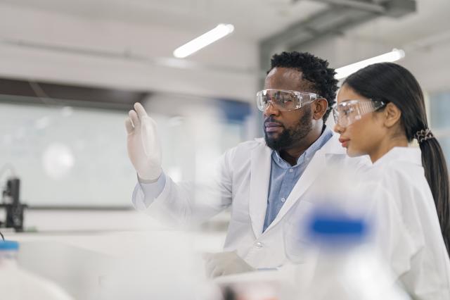 Two people in lab gear.