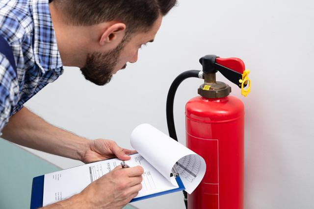 man reviewing fire extinguisher