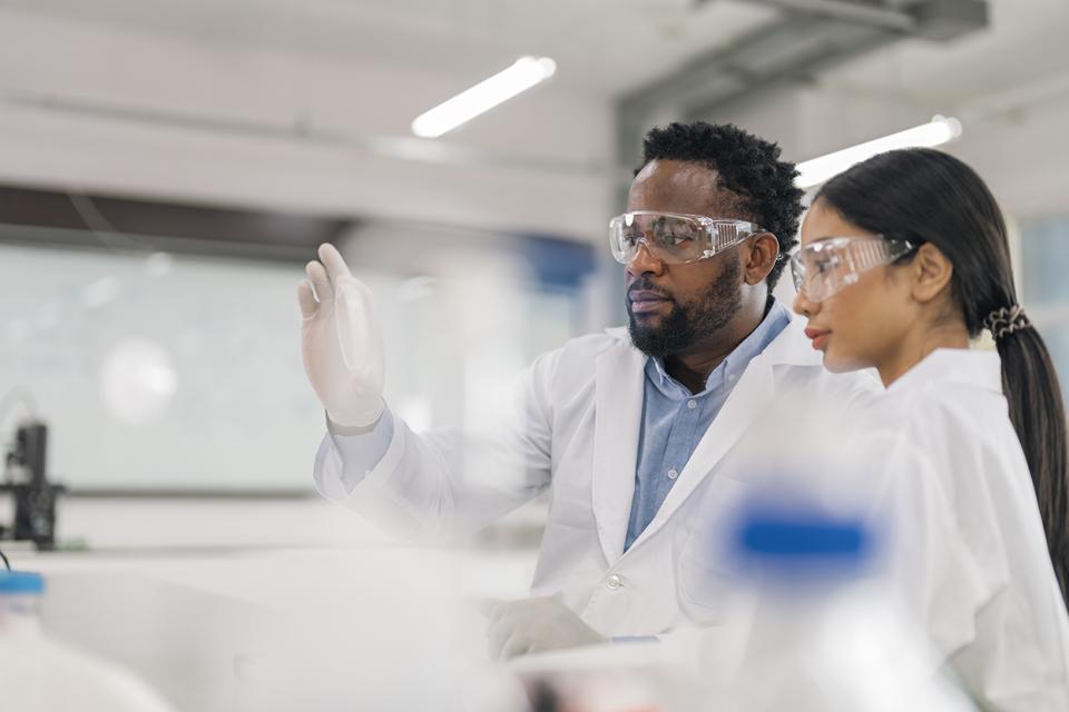 Two people in lab gear.