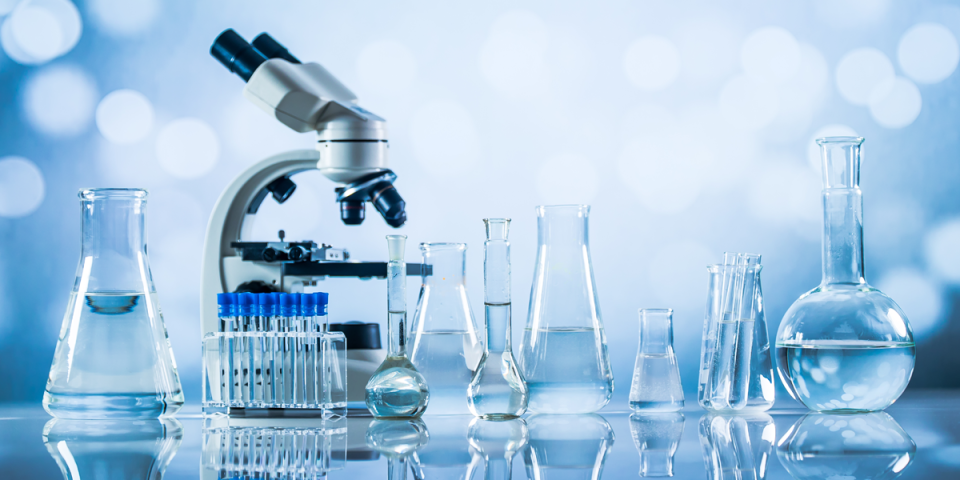 microscope and beakers with liquid