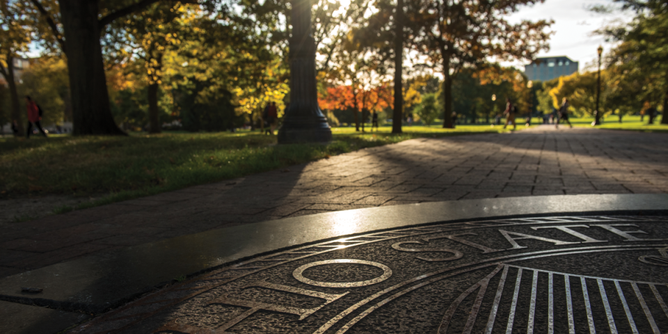 close up of university seal on oval in the fall